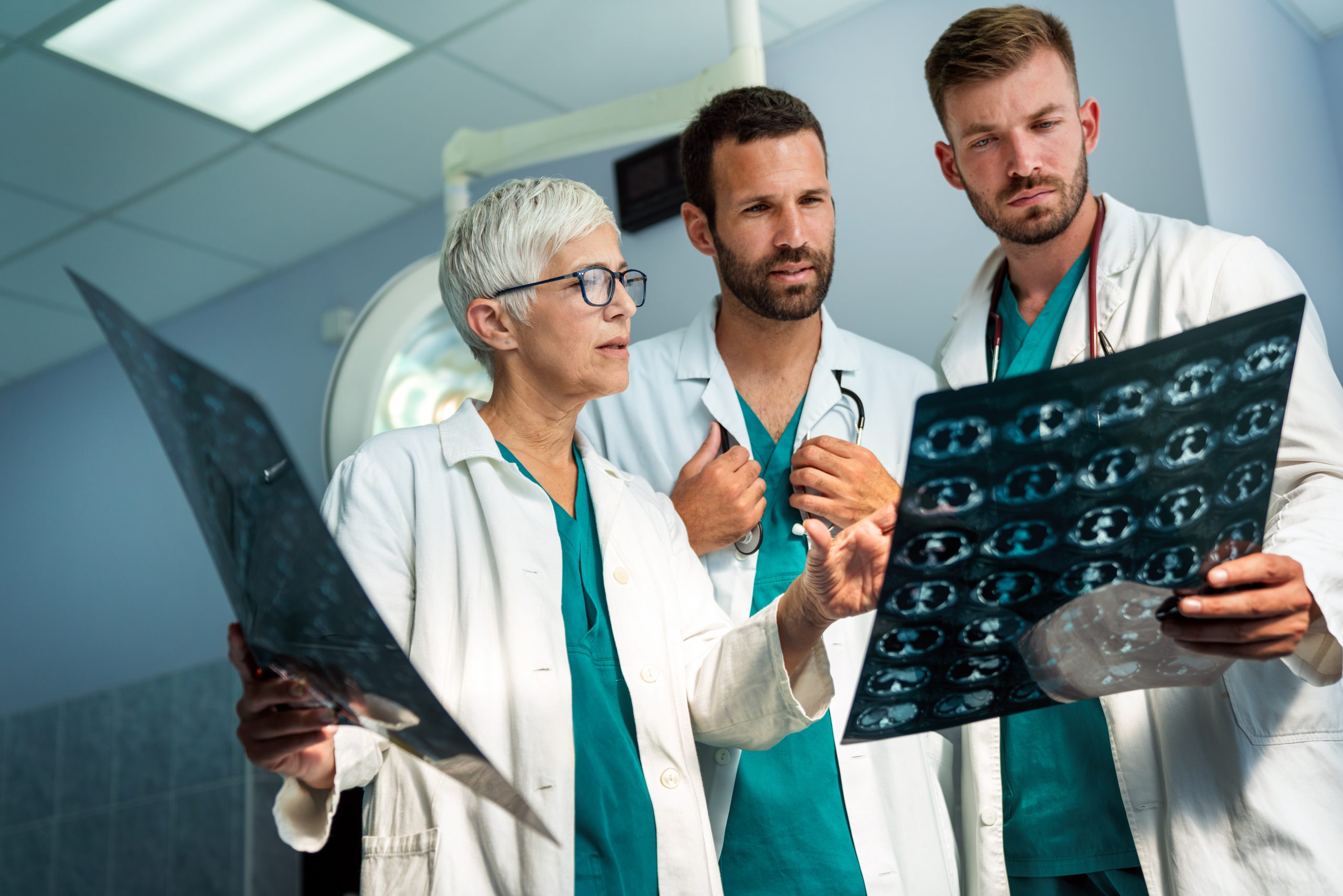 Group of radiology doctor looking at x-ray and discussing it. Health care, people concept
